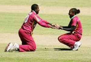 Pamela Lavine (L) and Shakera Selman (R) - Rare West Indies celebration against England after Lavine effects a run-out dismissal. (CMC photo)     