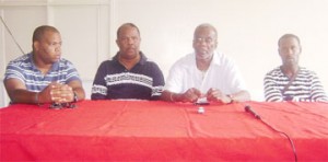 President of Alpha United Football Club Odinga Lumumba, second from right and officials of the Tempete Football Club at yesterday’s press briefing. (Rawle Toney photograph)   