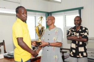 ‘MVP of the Competition’Pele’s Shemroy Arthur (L) receives the Most Valuable Player of the competition award from Mayor of Georgetown Hamilton Green as Head of the Mayor’s Cup organizing committee Lennox Arthur looks on. (Clairmonte Marcus photo) 