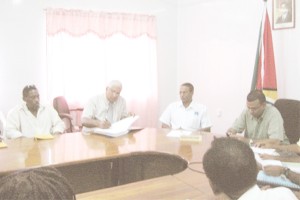 Raymond Latchmansingh (second from left) signing the contract. (GINA photo)