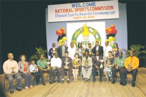 We are all winners!  Winners and representatives show off their trophies as Acting President Samuel Hinds, third left, is flanked by far left, Junior Sportsman of the Year Clevon Rock, NSC Chairman Conrad Plummer; right double winner Alika Morgan , Shivnarine Chanderpaul, Minister of Sports Dr. Frank Anthony, Director of Sports Neil Kumar and runner-up Junior Sportswoman of the Year Keisha Jeffrey. (Photo by Aubrey Crawford)