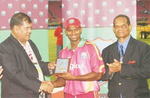 Shivnarine Chanderpaul is all smiles as he receives the plaque from Guyana Cricket Board president Chetram Singh. At right is Dr Julian Hunte. (Orlando Charles photo) 