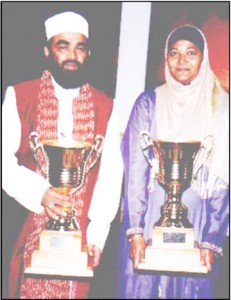2005 International Qaseeda senior competition winners Hajji Abdus Sattaur Yanki of Holland and Guyanese Shameeza Sakur display their trophies. 