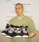 Carlos Mendez holding the two pairs of Nike sneakers which he has donated to this year’s Victory Valley Royals Inter-School Basketball Tournament. (Photo courtesy of Linden Alphonso)  