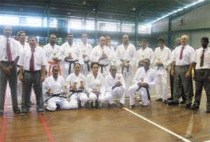 The karatekas take time out after competing to pose with the judges who are Marvin Singh (left) and Christopher Chaves (second left), Nandra Lall (right) Amir Khouri (second right) and Winston Dunbar (partly hidden behind Khouri).                                        
