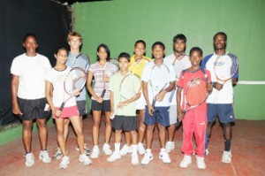 Good luck! National lawn tennis coach Shelly Daly-Ramdhyan (left) poses with the team to Barbados from left (front) Under-14 Krystal Sukhra, Daniel Lopes, Gavin Lewis and Seanden David-Longe. From left (back) Under-19 Jonathan Antczak, Aruna Ramrattan, Tracy Azeez, Rajesh Ramrattan and Jeremy Miller. (Clairmonte Marcus photo) 