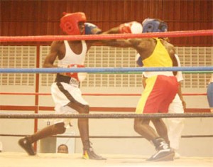 Night Two action! Two Forgotten Youth Foundation boxers Dexter Jordan (L) and Herlando Allicock (R) go at it hammer and tongs in their match on the final night of the GABA National Novices Championship at the National Gymnasium. (Orlando Charles Photo)  
