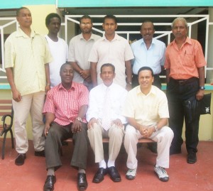 The 2009 GCF executive: Sitting – President Errol Tiwari, centre, is  flanked by (left) secretary Kenrick Braithwaite and (right) treasurer Shiv Nandalall. Standing from l-r are fund-raiser Dennis Dillon, chess trainer Learie Webster, vice-president Omar Sharyff, tournament director Irshad Mohamed, and committee members David Khan and Vishnu Rampersaud.