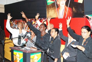 PPP members singing the party’s song at yesterday’s tribute to Mrws Jagan. (Photo by Jules Gibson)