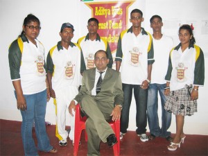  Narchand Mohan, president (seated at centre) posing with members of the local arm of the AKTFF and scholarship awardee, Dhanpaul Mohan (second from right). 