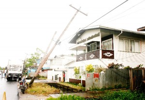 Fallen: The snapped electricity pole and the leaning poles at Hadfield Street yesterday.  