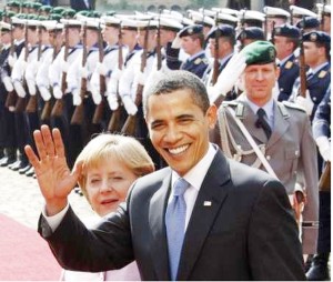 U.S. President Barack Obama waves as he and German Chancellor Angela Merkel inspect the guard of honour during a welcoming ceremony in Baden-Baden yesterday. REUTERS/Yves Herman (GERMANY) 