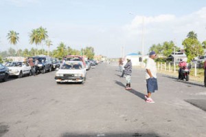 Cars lined up to cross the Berbice River Bridge