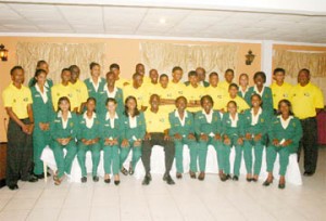 Members of the Guyana male under-15 and female under-19 teams respectively took time out from their dinner for a photo opportunity in the dining room of the Waterchris Hotel Friday night. Sitting fourth from left is Under-15 skipper Shaquille Williams, with female under-19 skipper Shamaine Campbell on his left. (An Orlando Charles photo) 