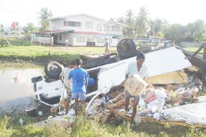 The Canter truck at the corner of the canal after it careened off the roadway at Number 19 Village in Berbice.