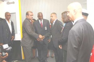 President Bharrat Jagdeo (second from left) being greeted on arrival yesterday in Trinidad for the Fifth Summit of the Americas. At left is presidential advisor Odinga Lumumba. (See page 10)