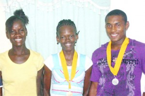 From left, Janella Jonas, Jevina Straker and Ricardo Martin after the press briefing yesterday at the Guyana Olympic House. (Orlando Charles photo)
