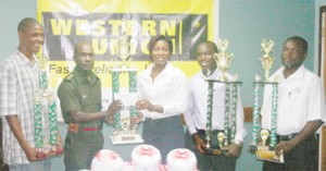 GFA’s First Vice-President Tyron Smith (2nd L) receives the sponsorship cheque and tournament trophy from Managing Director of Grace Kennedy Natheeah King while GFA’s Secretary Marlon Cole (2nd R), Lyall Gittens (L) and Western Union’s Vaughn Alleyne display the trophies that will be awarded to the other top finishers. (Orlando Charles photo)  