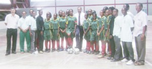 Minister of Sport Dr. Frank Anthony (centre) along with other Ministry officials pose with the historic IGG female football team that will be competing today.   			 