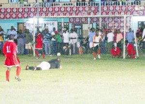 Watched by his teammate Carlos Kingston (number 11), a crestfallen Golden Stars custodian Owen Adonis (on ground) looks on as Telson Mc Kinnon celebrates scoring the equalizer for his team. (Orlando Charles photo) 