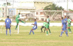 Suriname’s Esperance Evani (No# 9) is seen attempting the strike which gave his team the lead against French Guiana in the 42nd annual Inter Guiana Games Football Championship at the Ayanganna Ground, yesterday. (Orlando Charles Photo)  