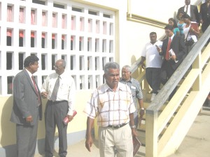 Persons leaving the meeting yesterday. Standing at left are Moen Mc Doom and Ralph Ramkarran