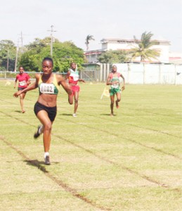 Girl Power! Nadine Rodrigues (wearing 1002) approaches the finish line to take gold ahead of team-mate Roxanna Rigby (far right) in the female 200m on day two of the IGG Track and Field Championship, Suriname’s Danielle Clark (2nd r) claimed bronze. (Orlando Charles Photo)   