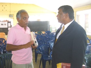 Member of the concerned group, Chartered Accountant Christopher Ram (left) speaking to Chairman of the NBS board, Dr Nanda Gopaul.