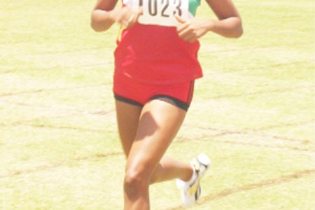 Suriname’s Ilsida Toemere crosses the finish line unchallenged in the female 3000m on the final day of the Inter Guiana Games Track and Field Championship at the Eve Leary Sports Complex Ground yesterday. (Orlando Charles Photo)  