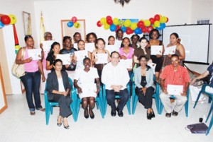 The students pose with their certificates along with their lecturers and invitees. Sitting at centre is Ambassador Dario Morandy.   