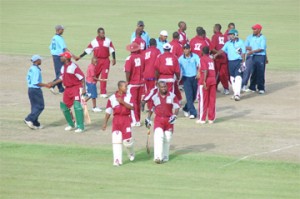 Cowen Ismond and Travis Dowlin (foreground) of Demerara Cricket Club (DCC) leave the field, as their teammates exchange congratulations with their opponents, Lusignan Cricket Club (LCC) after the seven-wicket victory.