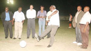 Minister of Public Works Robeson Benn makes the ceremonial kick off. (Orlando Charles Photo) 