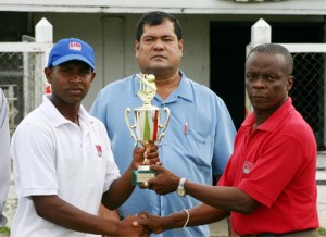 Rajendra Nikbarran (left) receives his Man-of-the-Match trophy from GTM’s Unit Manager Edward Hackett while president of the Guyana Cricket Board (GCB) Chetram Singh (centre) looks on. (Orlando Charles photo)  