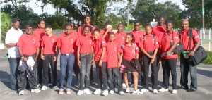 The national junior table tennis team minus Varsha Panday and Dillon Mahadeo, strike a pose with coaches Colin France (left back row) and Leon Johnson (right back row) at the CASH prior to their departure. (An Orlando Charles photograph)  
