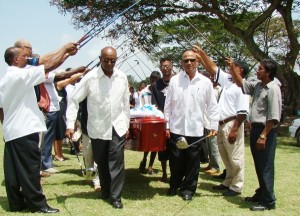 Players and caddies made an arch with their golf clubs in a salute following a brief viewing at the Lusignan Golf Course.  