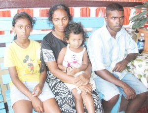 A distraught Shanti Elfreeda Kooblall (centre) holds her granddaughter while her son and daughter, Akash and Rona sit at her  right and left respectively.