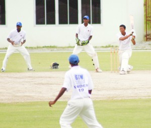Berbice middle order batsman Jonathan Foo launches into the Demerara bowling attack during his unbeaten 50 in his team’s first innings score of 75-4 in reply to Demerara’s 214. (Orlando Charles photograph)