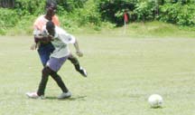 Action between Grove North and Caneville in the Sports Ministry inter-block football tournament (Rawle Toney photo)    