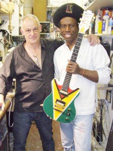 Eddy Grant (right) holds his ‘Ringbang Guyana’ guitar. At left is the guitar maker, Philippe Dubreville a Frenchman living in England. (Photo courtesy of Eddy Grant) 