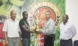 Banks DIH Sales and Marketing Executive Carlton Joao (2nd R) presents the Banks Premium Beer Trophy to Camptown’s Rishawn Sandiford (2nd L) as Camptown’s Vice President Leroy Prescot (left) and Banks’ Public Relation Officer Troy Peters (right) look on. 