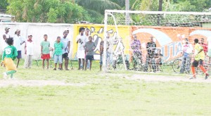 ‘The Decider! Fruta Conquerors’ custodian could only watch as the ball fired by Kimba Braithwaite (L) rockets past him in the penalty shootout while spectators stare in astonishment. (Photo by Orlando Charles) 