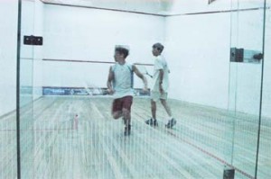 Steven Xavier (front) gets back to execute a back shot in his match against Ryan Da Silva during the third night of action in the Guyana Squash Association/ Woodpec-ker Products national junior championships. (An Aubrey Crawford photograph) 