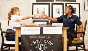 During the recent US Chess Championship that was held at the St Louis Chess Club and Scholastic Center, students from schools in the vicinity experienced the thrill of playing chess at the same tables in the same room where the championship was being contested. The games were played on the off-day of the nine-round tournament. In the photo, two serious chess players, perhaps aspiring grandmasters, observe the time-honoured handshake before the commencement of their hostilities over the chessboard. 