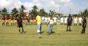 Western Union’s Marketing Executive, Nateaah King (centre) kicks the ball off to start yesterday’s league tournament while GFA’s Operations Manager Lyall Griffith (2nd L), members of the Referee Association and teams look on. (Orlando Charles Photo) 