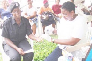 Glynis Beaton (right) testing a member of the public during an outreach activity last year.