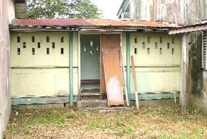 The broken back door of Uncle Eddie’s Home through which the robbers gained entry to the building. (Photo by Orlando Charles)  