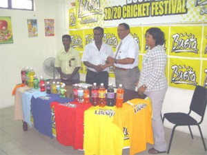 General Manager of Guyana Beverage Company Robert Selman hands over the sponsorship cheque to president of the Enterprise Busta Sports Club Karran Ramdhoon while vice-president Jitlal Jowharilalol and Shameiza Yadram look on.