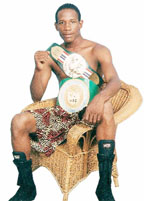 Leon ‘Hurry-Up’ Moore proudly poses with his WBC Caribbean Boxing Federation (CABOFE) bantamweight and NABA bantamweight titles. 