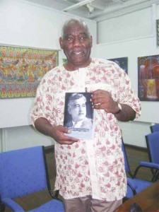 Professor Sewlyn Cudjoe poses with a copy of his book Caribbean Visionary: A.R.F. Webber and the Making of the Guyanese Nation at Castellani House on Thursday. 