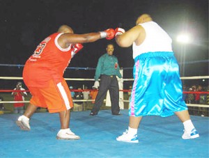 Sparks fly when the two giants touch gloves! ‘Big Bad’ Shawn Harris of Georgetown (left) and Fahaad ‘The Linden Giant’ Ali feeling each other out during the earlier stages of their fight at the McKenzie Sports Club ground which ended in a draw.  